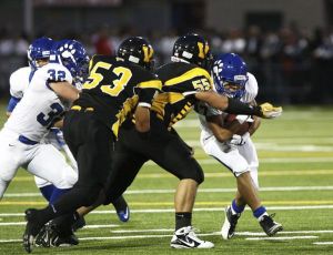 Viking defensive linemen Mikey (No. 53) and Niko Tupou (No. 55) try to take down a Bothell rusher during the Spaghetti Bowl at Pop Keeney earlier this fall. The Cougars won their 10th straight regular-season meeting against the Vikings