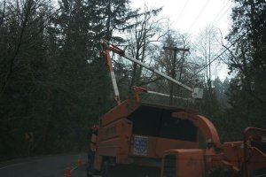 Crews fix a broken power line at a street near Juanita Dr. N.E.