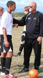 Cliff McCrath instructs a player at a Northwest Soccer Camp session at Camp Casey.