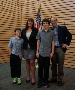 Stacey Denuski stands with her family during a Kenmore City Council meeting.