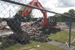 Construction crews worked to clear the way for the new Bothell City Hall project on Wedneday in downtown Bothell. This building used to house the Greater Bothell Chamber of Commerce.