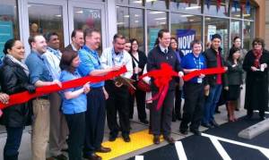 Bothell Mayor Mark Lamb (holding bow) helps employees of the new Sears Home and Appliance store in Bothell celebrate with a ribbon cutting ceremony and grand opening event.