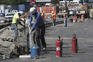 Workers lay cement for the inside curb of the new SR 522 route through Bothell on Tuesday. The Crossroads Project is almost ready to shift traffic to the newly aligned section of SR 522. Major portions of road will be closed starting at 9 p.m. on Aug. 9 until 5 a.m. Aug. 12 in order to switch traffic to the new roadway alignment. During this time