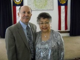 First Husband Mike Gregoire and Bothell American Legion Post 127 hostess Johanna Gabuag visit at the legion's annual luncheon to 'Honor Women Veterans' March 6.