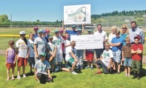 State Sen. Andy Hill presents a symbolic check for $750