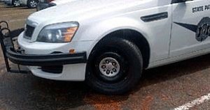 The left front wheel of this Washington State Patrol car was damaged during a collision on I-405 and the vehicle is unable to steer.