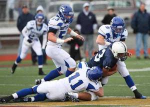 Bothell High's Eric Gregory (9) and Greg Williams (11) tackle Bellarmine Prep quarterback Sefo Liufau as Ryan Romeis (53) watches.
