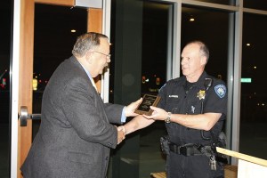Kenmore police officer Mark Childers receives an award from Kenmore mayor David Baker for being honored as the Washington School Resource Officer of the Year. Childers has been an SRO in the Northshore School District for the past 17 years.