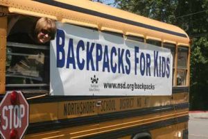 Cecilia Shumate peeks out of the window of the school bus parked at Fire Station 45 in Bothell.