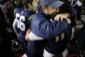 Cedar Park Christian football coach Bill Marsh hugs senior Josiah Sergeant following the Eagles&rsquo; 28-25 victory over Cedarcrest on Oct. 22 at Juanita High School. Sergeant rushed for 265 yards and four touchdowns. JOHN WILLIAM HOWARD/Bothell-Kenmore Reporter