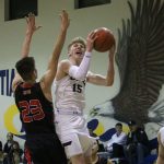 Cedar Park&rsquo;s George Reidy (15) takes contact from Seattle Christian&rsquo;s Zac VanderLay in the first half of the Eagles&rsquo; 49-45 victory on Tuesday. Reidy finished with 13 points for Cedar Park, while VanderLay led the Warriors with 23. JOHN WILLIAM HOWARD/Bothell-Kenmore Reporter