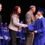 Luis Camarena of Kenmore graduates from the Washington Youth Academy on Dec. 17 and is congratulated by Major General Bret Daugherty and Secretary of State Kim Wyman. Contributed photo
