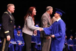 Luis Camarena of Kenmore graduates from the Washington Youth Academy on Dec. 17 and is congratulated by Major General Bret Daugherty and Secretary of State Kim Wyman. Contributed photo