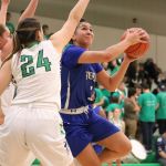 Bothell senior Taya Corosdale (5) looks for a shot past the outstretched arm of Woodinville&rsquo;s Gabriella Walen in the first half of Friday&rsquo;s game at Woodinville High School. Corosdale led Bothell to a 52-48 win with 17 points.JOHN WILLIAM HOWARD/Bothell-Kenmore Reporter