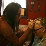 Kirkland artist Sarah Walters creates a henna crown for Mary Glasco at Sankara Imports in Bothell. CATHERINE KRUMMEY/Kirkland Reporter