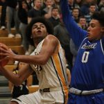 Inglemoor&rsquo;s Jalen Woodley (33) scoups a shot past Bothell senior Isaiah Clark (0) in the first half of Friday&rsquo;s KingCo Conference game at Inglemoor High School. JOHN WILLIAM HOWARD/Bothell-Kenmore Reporter