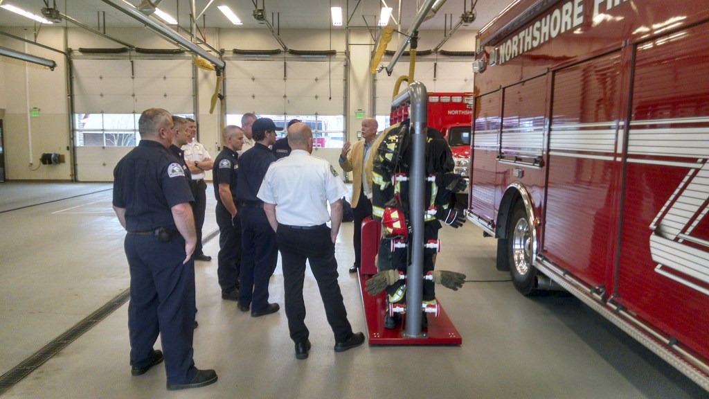 Ram Air Gear Dryer Director of Sales David Adams (right) explains how this equipment dryer, won in his company&rsquo;s Hometown Heroes contest, works to Northshore Fire Department staff. CATHERINE KRUMMEY / Kenmore Reporter