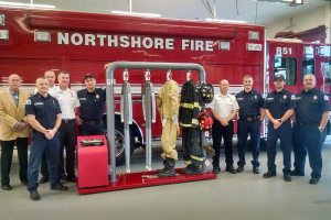 Ram Air Gear Dryer Director of Sales David Adams (left) presents a dryer, won in his company&rsquo;s Hometown Heroes contest, to Northshore Fire Department staff in Kenmore. CATHERINE KRUMMEY/Kenmore Reporter