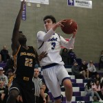 Bothell&rsquo;s Josh Kollman shoots over Inglemoor senior Chinedu Ugokwoli. Kollman finished with seven points for the Cougars. JOHN WILLIAM HOWARD/Bothell-Kenmore Reporter
