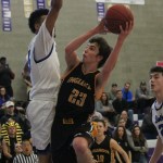 Inglemoor senior Ryan Hamilton (23) challenges Bothell&rsquo;s Cameron Tyson at the rim in the second half of Saturday&rsquo;s game at Lake Washington High School. JOHN WILLIAM HOWARD/Bothell-Kenmore Reporter