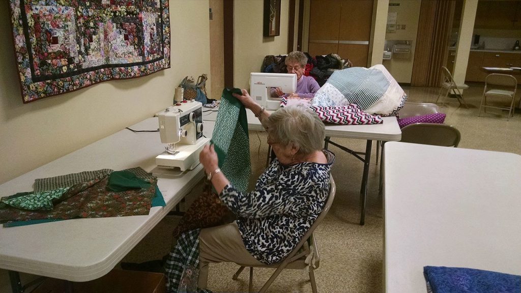 Betty Magee and Helga Smith work on quilts at First Lutheran Church of Bothell on Feb. 2. CATHERINE KRUMMEY / Bothell Reporter