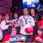 Chef John Howie (center) and former Seattle Seahawk Craig Terrill are joined by John Howie Restaurants employees to raise money for Food Lifeline as part of the NFL&rsquo;s Kick Hunger Challenge. Contributed photo