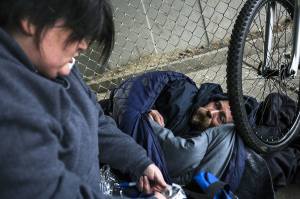 Gretchen Holtz, a volunteer from Compass Health, gathers information from Steve near the Everett Gospel Mission during the annual Point in Time Homeless Count on Tuesday, Jan. 24, 2017 in Everett. Volunteers conducted interviews and passed out resources in areas throughout Snohomish County. (Daniella Beccaria / The Herald)