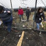 Gretchen Holtz (left) and Autumn Manning (right), both volunteers from Compass Health, leave the train tracks through holes in a fence with Officer Inci Yukurt and Law Enforcement Social Worker Kaitlyn Dowd after finding an empty camp during the annual Point in Time Homeless Count on Tuesday, Jan. 24, 2017 in Everett. (Daniella Beccaria / The Herald)
