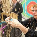 Nancee Hofmeister, Vice President of Nursing and Chief Nursing Officer at EvergreenHealth, ties a ribbon during a dedication ceremony for the hospital&rsquo;s new progressive care unit on Friday, March 3. JOHN WILLIAM HOWARD/Kirkland Reporter