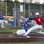 Bothell&rsquo;s Brody Ponti evades Cascade pitcher Steven Maynard as he slides home after a wild pitch Thursday at Bothell High School (Joe Livarchik/staff photo).