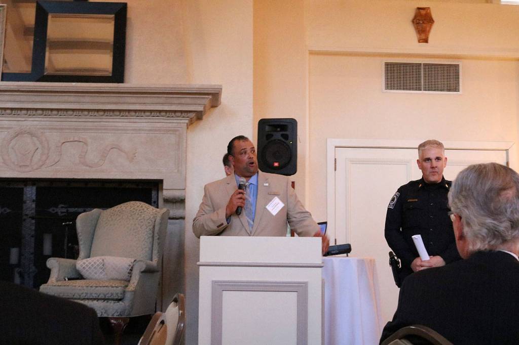 Bothell City Councilmember James McNeal and Bothell Police Captain Mike Johnson give a presentation on the &ldquo;Cops and Cards&rdquo; program at a Sound Cities Association dinner in Kenmore. CATHERINE KRUMMEY / Kenmore Reporter