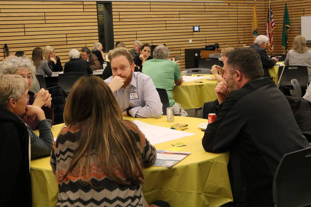 Locals, including Kenmore City Councilmember Nigel Herbig (center), participate in a &ldquo;For the Love of Kenmore&rdquo; event at Kenmore City Hall. CATHERINE KRUMMEY / Kenmore Reporter