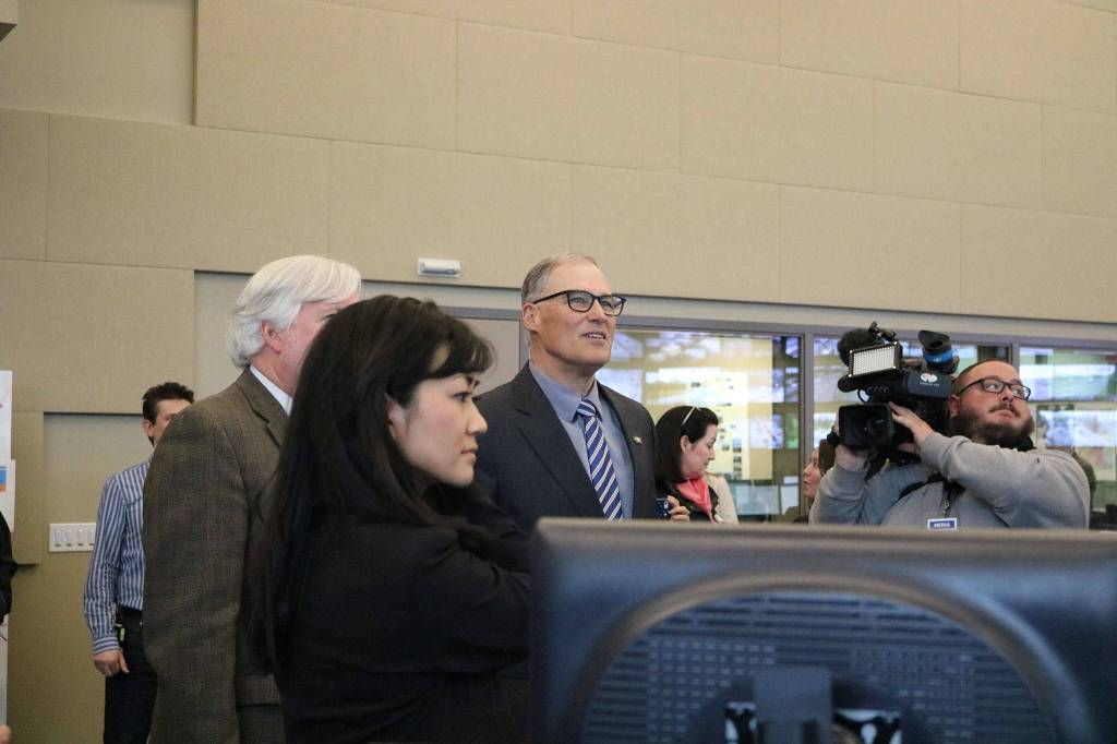 Gov. Jay Inslee takes a look at traffic camera footage at the Washington State Department of Transportation&rsquo;s traffic management center in Shoreline. CATHERINE KRUMMEY / Bothell Reporter