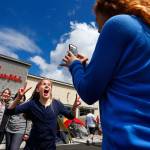A girl jumps in front of the camera as another girl takes a picture at the opening of the Lynnwood Chick-Fil-A in 2015. The popular fast-food restaurant is opening in Bothell and continues to see explosive growth despite past controversies. (Everett Daily Herald file photo)