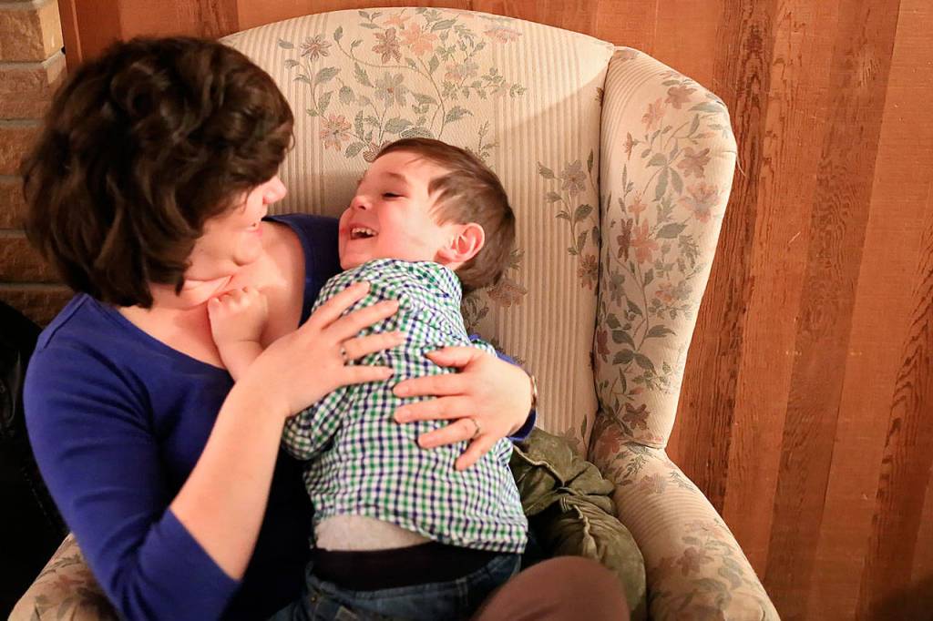 Deanna Fisher tickles her youngest autistic son, Colin, 4, at their home in Bothell. The Fishers are volunteering baby teeth for a study to determine if prenatal exposure to chemicals increases a child&rsquo;s chances of developing the autism. (Kevin Clark / The Herald)