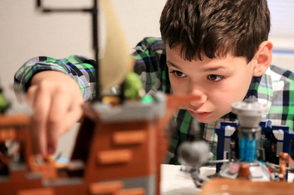JT Fisher, 11, plays with Legos at his home in Bothell. The Fishers are volunteering baby teeth for a national study to determine if prenatal exposure to chemicals increases a child&rsquo;s chances of developing the autism. (Kevin Clark / The Herald)