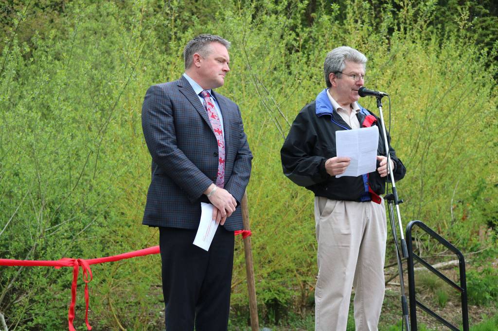 Bothell Mayor Andy Rheaume listens as Help Our Woods&rsquo; Paul Clement addresses the crowd. CATHERINE KRUMMEY / Bothell Reporter