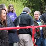 Local officials, including Bothell Deputy Mayor Davina Duerr, and others involved in the acquisition process prepare to cut the ribbon to celebrate the city&rsquo;s procurement of all of North Creek Forest. CATHERINE KRUMMEY / Bothell Reporter