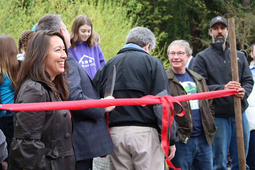 Local officials, including Bothell Deputy Mayor Davina Duerr, and others involved in the acquisition process prepare to cut the ribbon to celebrate the city&rsquo;s procurement of all of North Creek Forest. CATHERINE KRUMMEY / Bothell Reporter