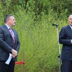Gov. Jay Inslee (right) was the guest of honor at the North Creek Forest ribbon-cutting ceremony. He praises those who had a part in the land acquisition process as Bothell Mayor Andy Rheaume listens. CATHERINE KRUMMEY / Bothell Reporter
