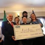 Secondary Academy for Success (SAS) student Dustin Lewis (center) is the recipient of this year&rsquo;s Greater Bothell Chamber of Commerce scholarship. He poses with the big check alongside chamber representatives and SAS staff. SAMANTHA PAK, Bothell Reporter