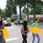Frank Love Elementary School staff and students use the new pedestrian flags at the intersection of Fourth Avenue West and 224th Street Southwest. CATHERINE KRUMMEY, Bothell/Kenmore Reporter