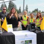 Bothell Mayor Andy Rheaume and flag program volunteer Marykay Branscomb celebrate the installation of pedestrian flags at a variety of intersections near Northshore School District schools alongside Frank Love Elementary School students. CATHERINE KRUMMEY / Bothell Reporter