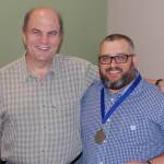 Doug Rough (left) embraces Steven Charie for saving his life at 24-Hour Fitness in Bothell. Charie was presented with the Award of Exemplary Action and the CPR Life Saving Award metal by the Bothell Fire Department, Shoreline Fire Department, King County EMS and Woodinville Fire and Rescue. Courtesy photo