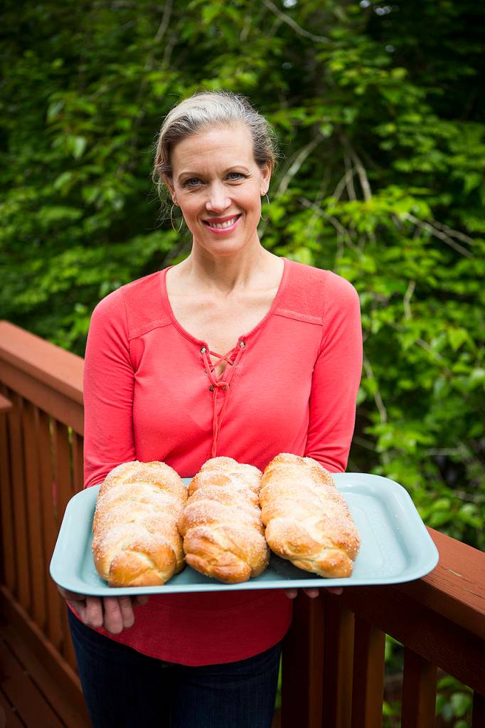 Joyce Sieben holds a fresh batch of her cardamom bread. Ian Terry, The Herald