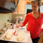 Ian Terry / The Herald Joyce Sieben coats her cardamom bread with an egg wash before baking the braided loaves at her home in Bothell. Photo taken on 05182017