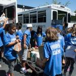Students from Evergreen Academy Elementary School&rsquo;s summer camp program pile the food and toiletry donations they collected onto a cart at Hopelink in Kirkland. Samantha Pak, Kirkland Reporter