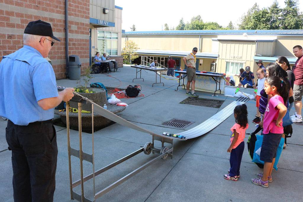 Children stand by at the Boy Scouts of America race their soap box derby cars down the track at the Back to School Fair Aug. 16. Megan Campbell, Bothell/Kenmore Reporter