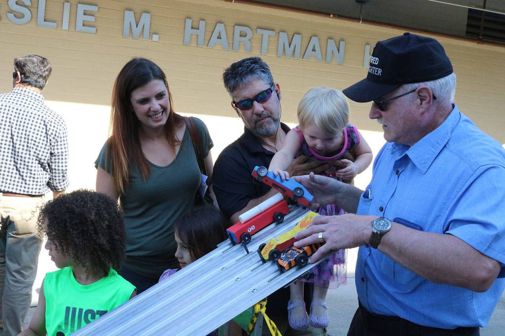 Kai Wiscomb, 3, helps put a soap box car on the track Aug. 16. Megan Campbell, Bothell/Kenmore Reporter