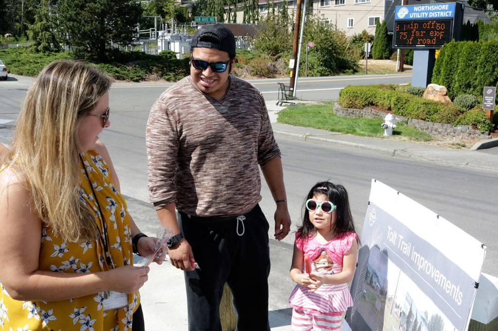 Community Relations Manager Leslie Harris speaks to Jesus Dios and his four-year-old daughter, Alyssa, during the ribbon cutting Aug. 23. Megan Campbell, Bothell/Kenmore Reporter